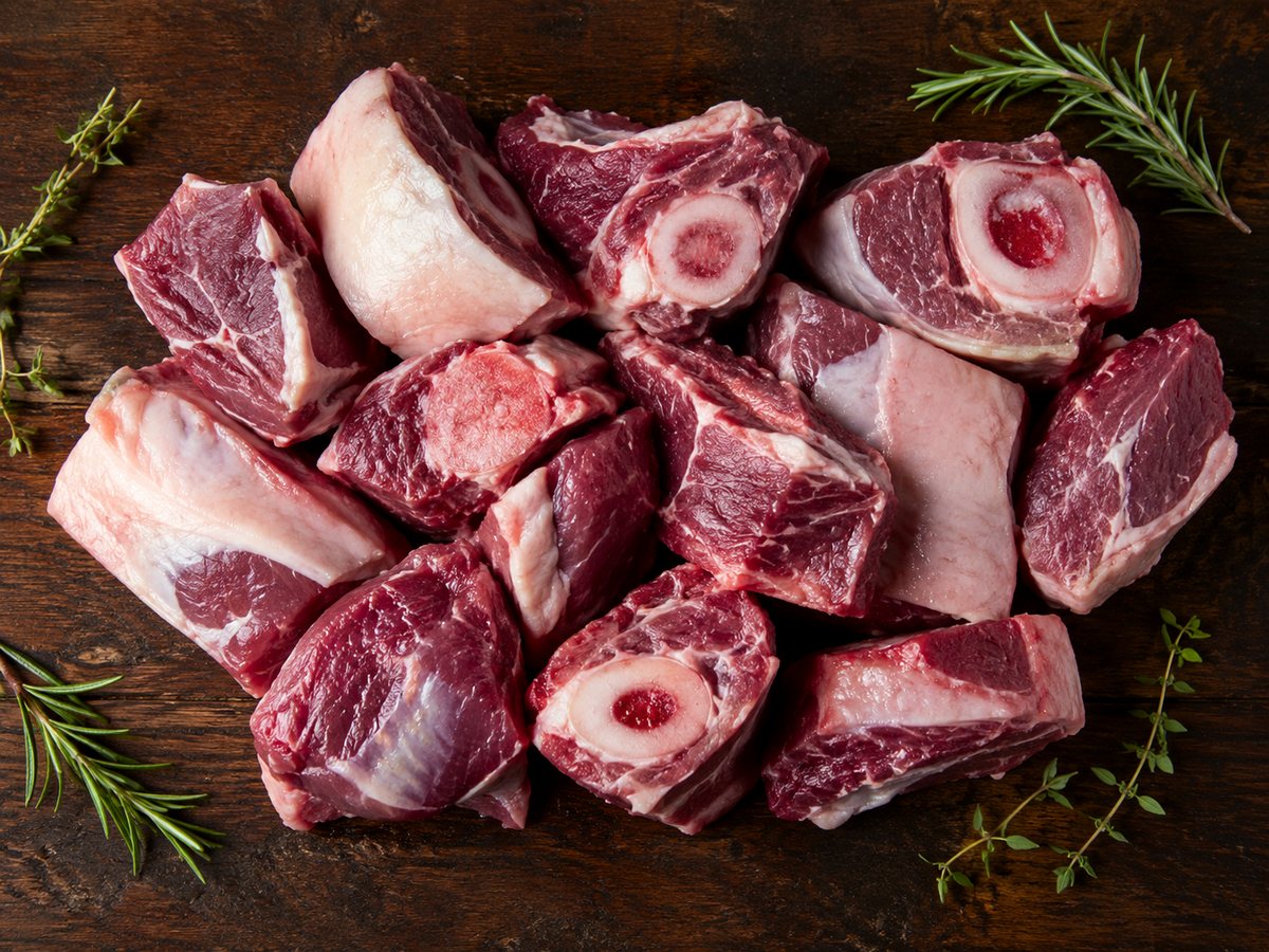 Fresh raw meat and herbs arranged for preparation